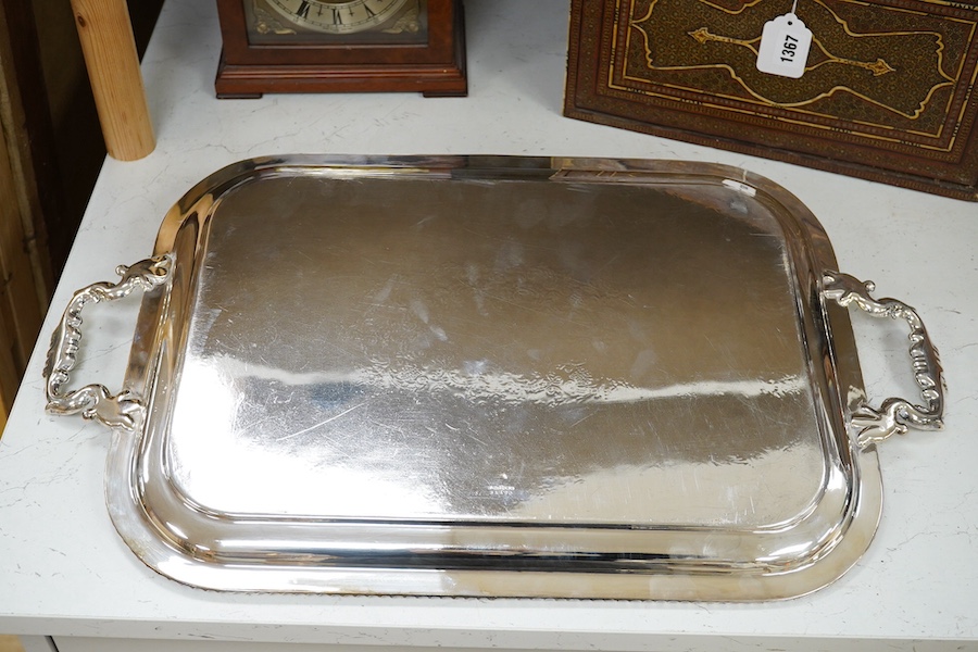 A two handled silver plated tea tray, 63.5cm wide. Condition - some scratches.